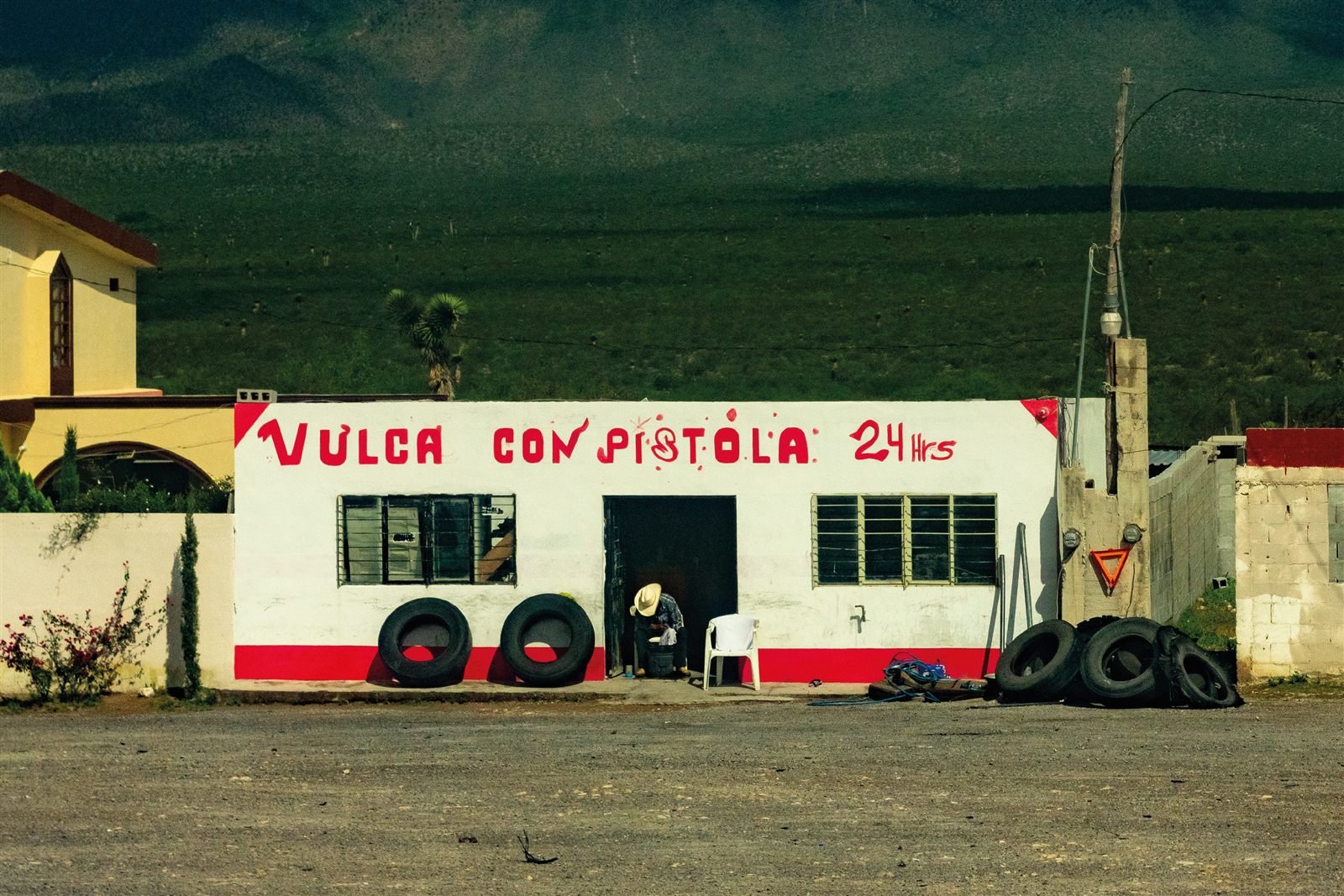 Photograph of a hand-painted tire shop mural in Mexico